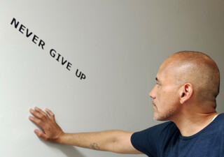man with never give up message at Able House